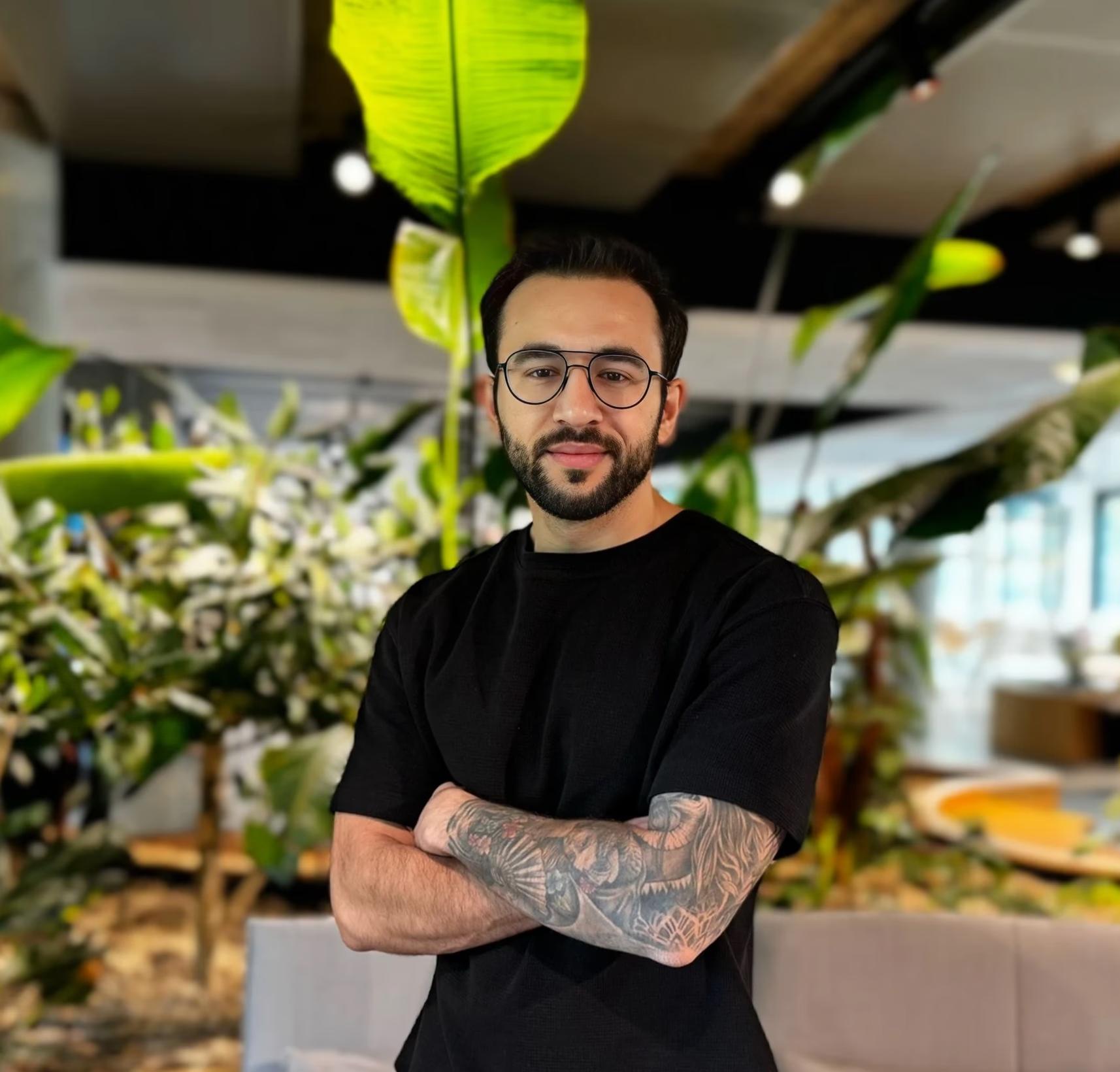 Alican Torun posing in an office environment